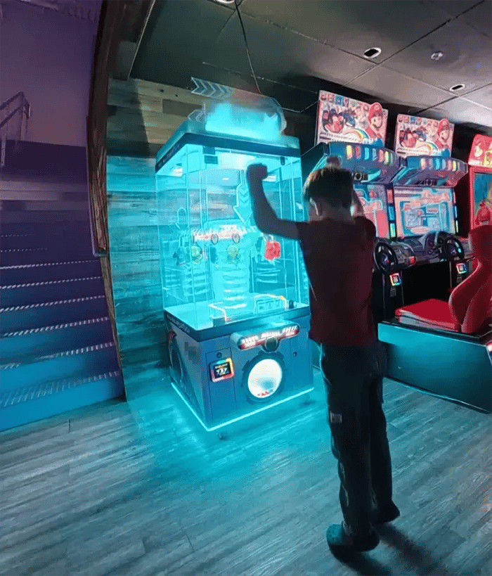 a kid winning a prize at Indy Karting's arcade